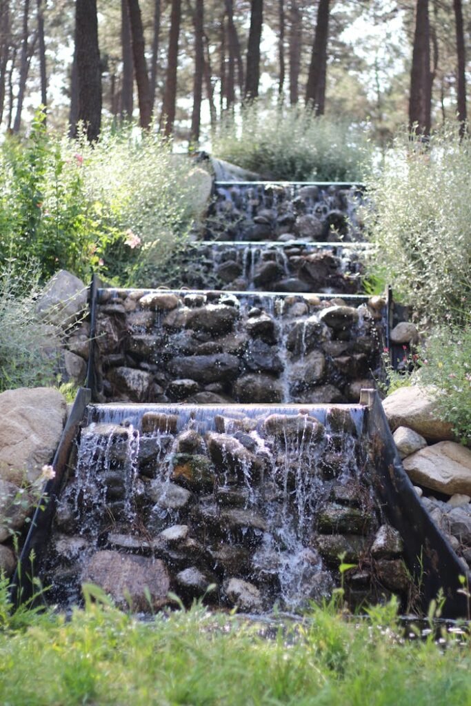Tranquil cascading waterfall in a lush forest garden, perfect for relaxation themes.